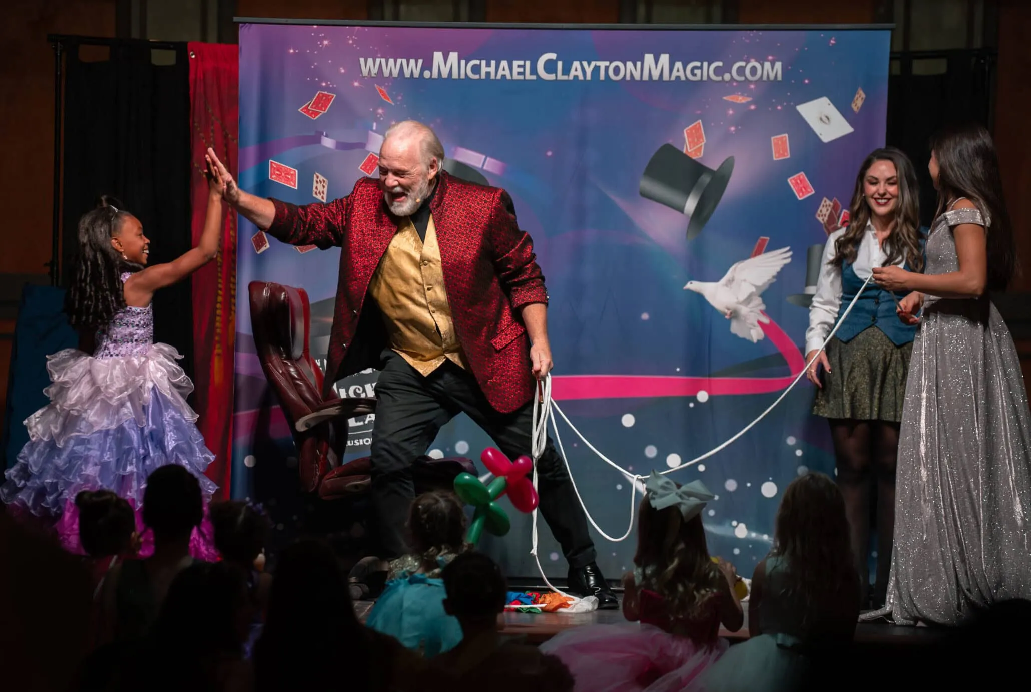 Magician Michael Clayton on-stage with audience members